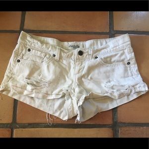 Distressed white jean shorts